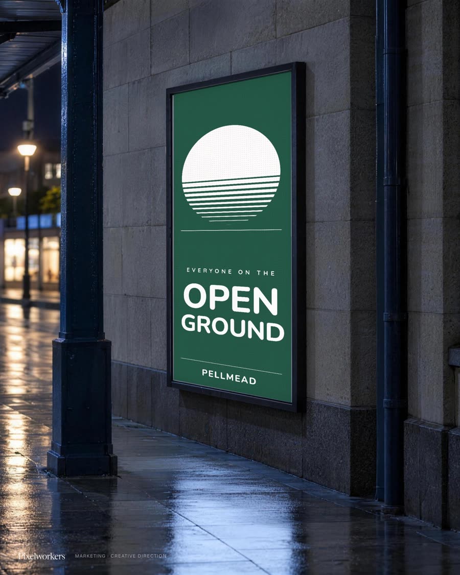 A backlit poster panel on a wet station platform at night carrying the festival's launch headline.