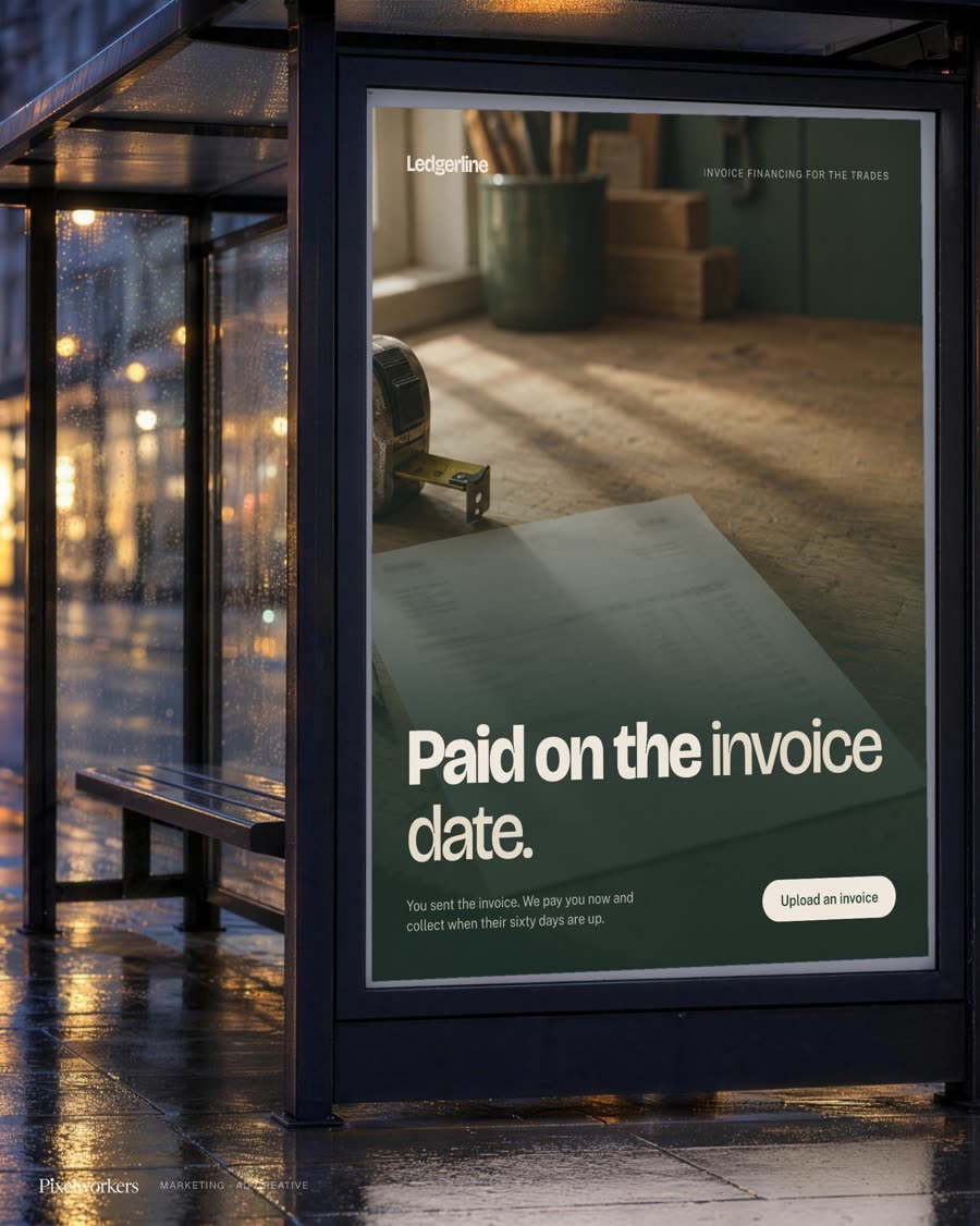 An invoice-financing campaign poster for small trade businesses, lit up in a bus shelter at night.
